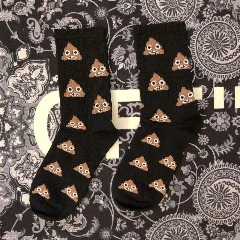 Black poop socks with emojis on a patterned bakground