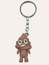 Brown poop emoji keychain with a cheerful smile on a metal keyring, against a plain background.