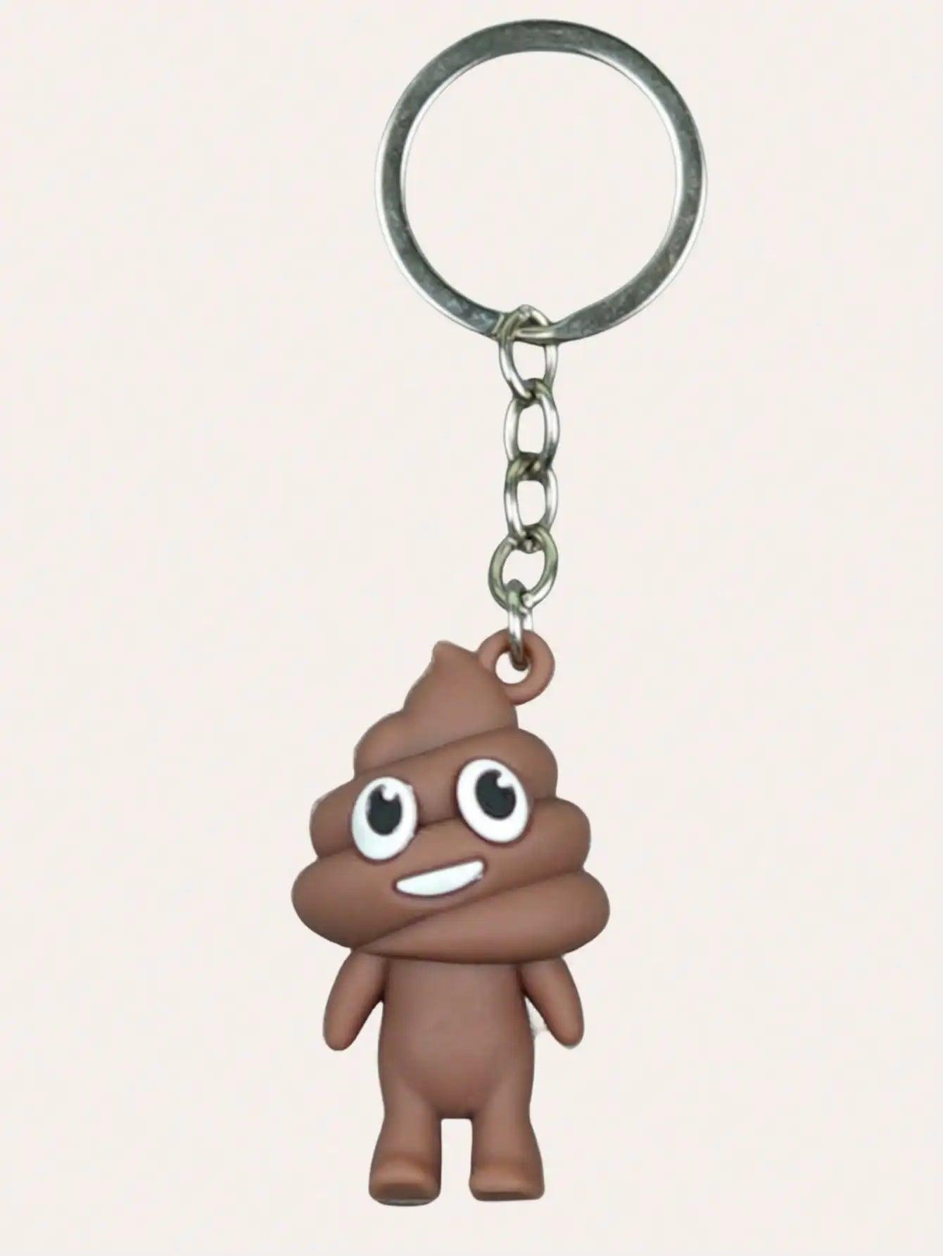 Brown poop emoji keychain with a cheerful smile on a metal keyring, against a plain background.