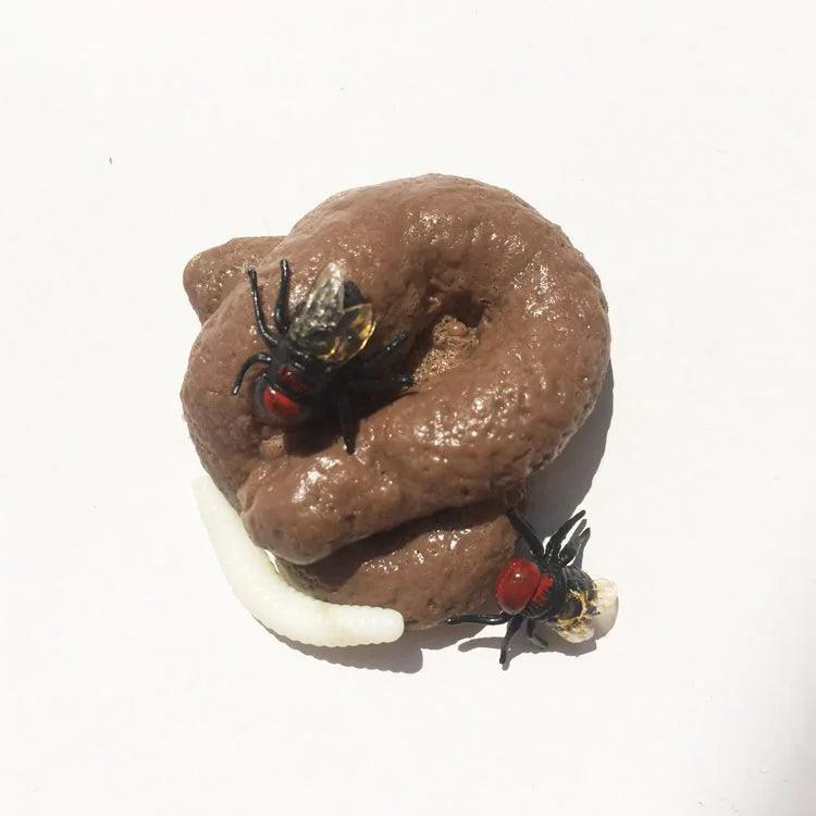 Realistic fake poop with toy flies and maggots on a white background, mimicking a natural scene.