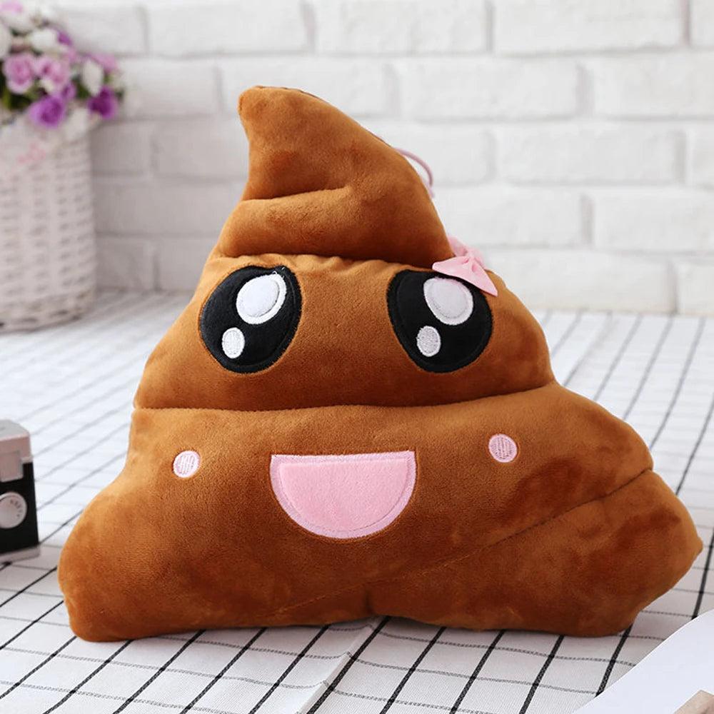 Adorable large poop emoji pillow with pink bow, brown, on checkered surface.