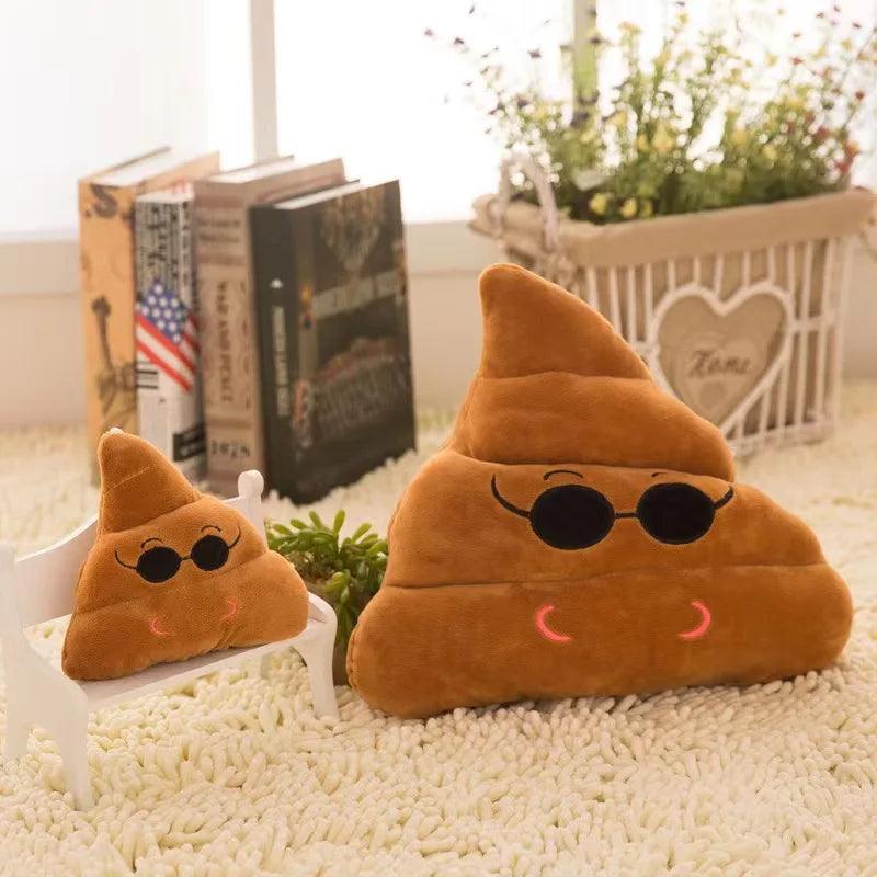 Two poop emoji pillows with sunglasses, brown plush on bench