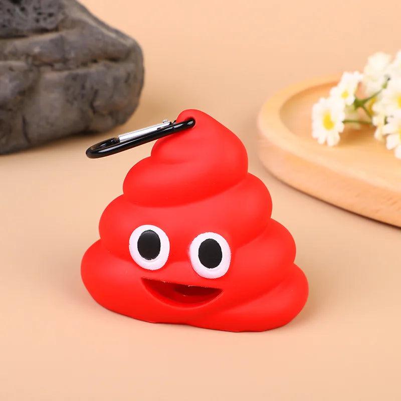 Red poop emoji poop bag dispenser with a carabiner clip, smiling brightly on a beige background with flowers.