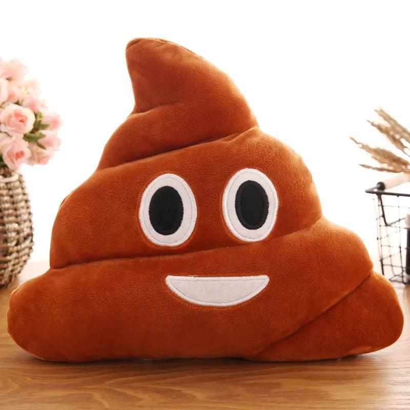 Close-up of a smiling pile of poop pillow, brown with cheerful face, on wood.
