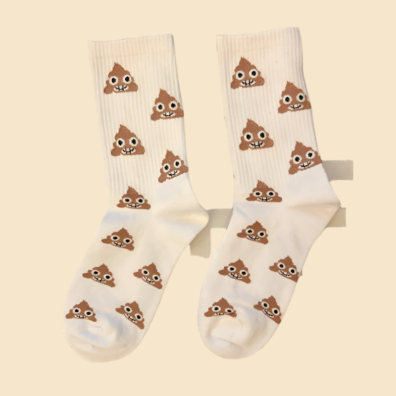White emoji poop socks on a pattern like table cloth