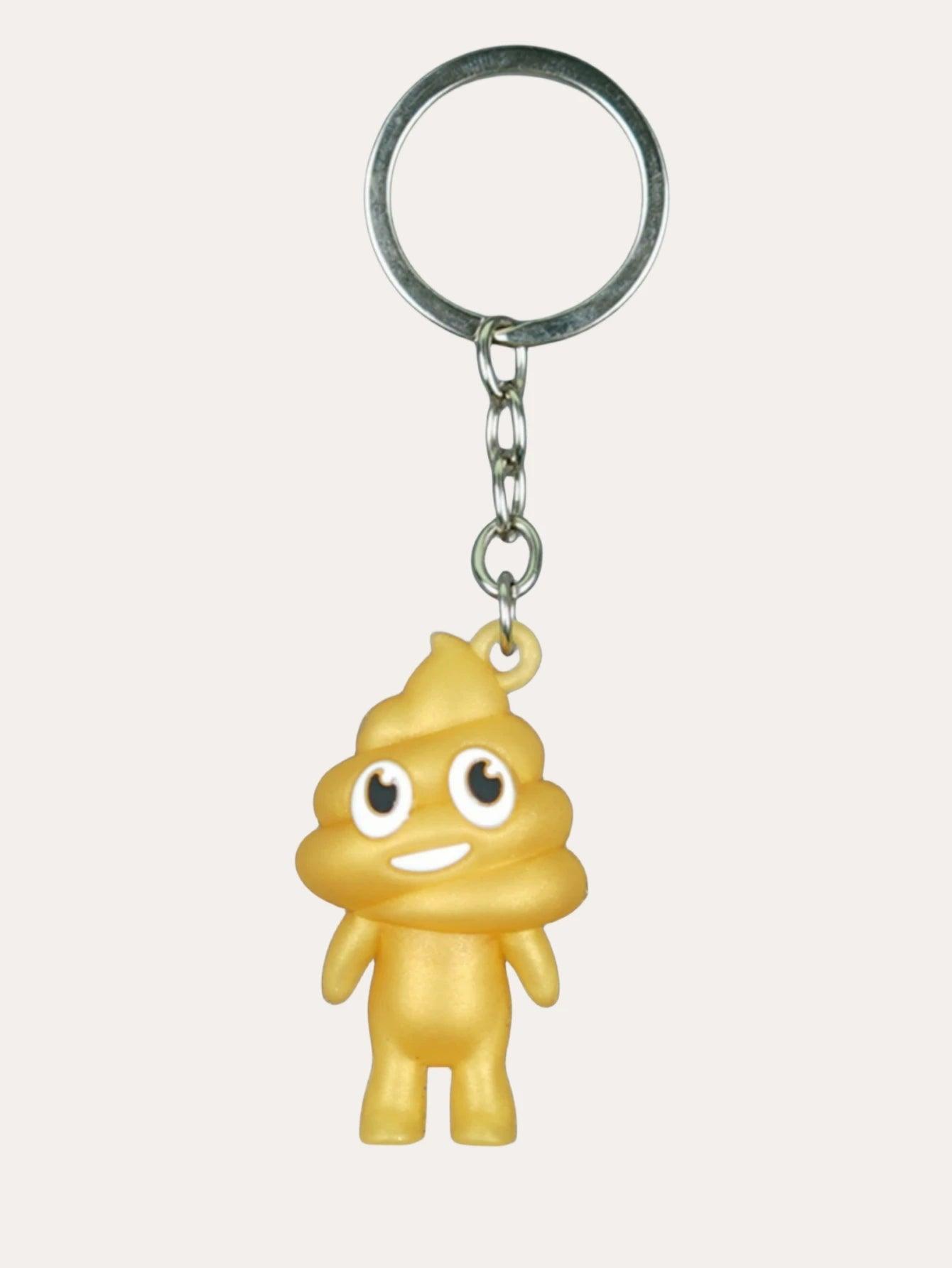 Yellow poop emoji keychain with a smiling face on a metal keyring, against a plain background.